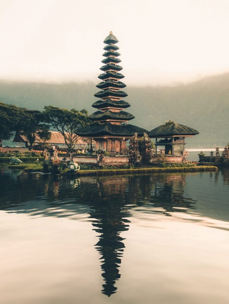 templo junto a um corpo de água e árvores