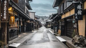 a narrow street in an asian city with snow on the ground