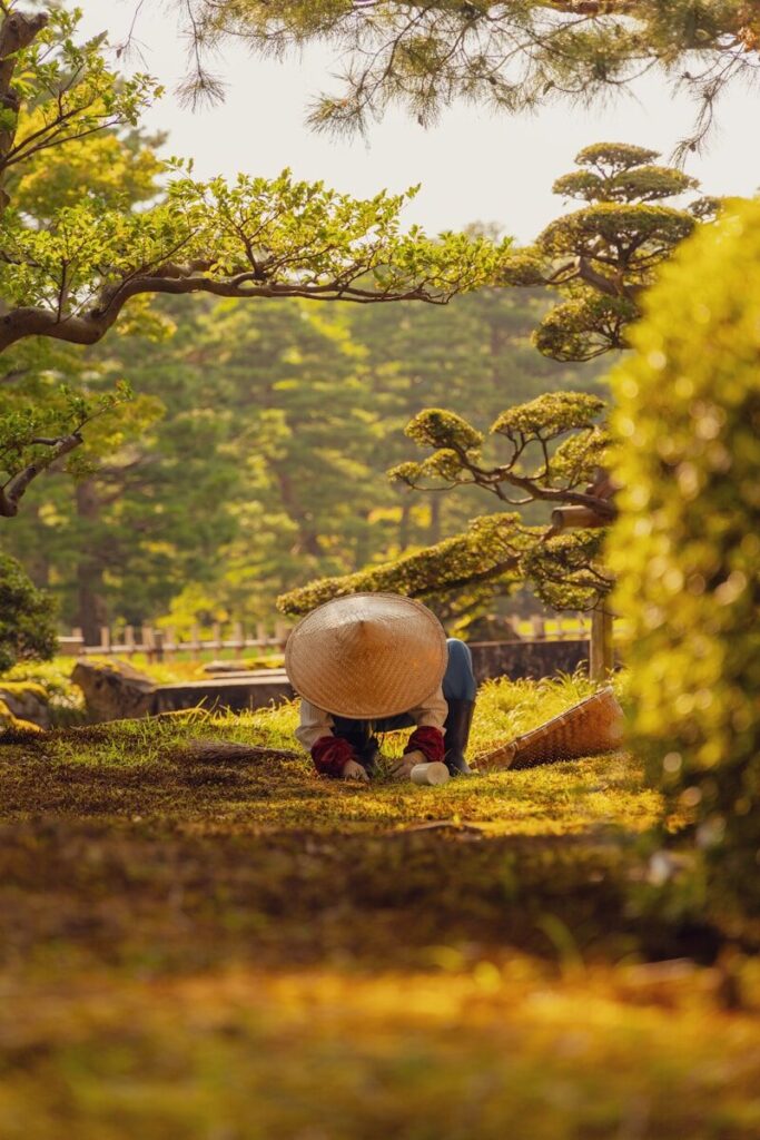 A person sitting on the ground with an umbrella