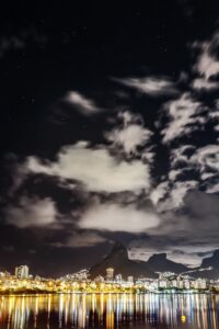 a view of a city at night with a mountain in the background
