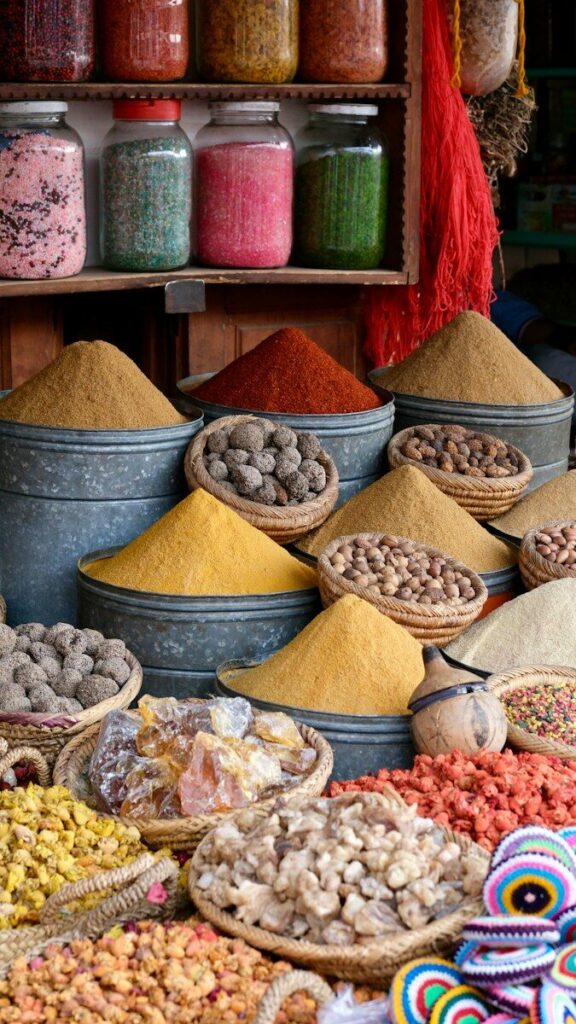 Cones of coloured spices in bowls at a market stall