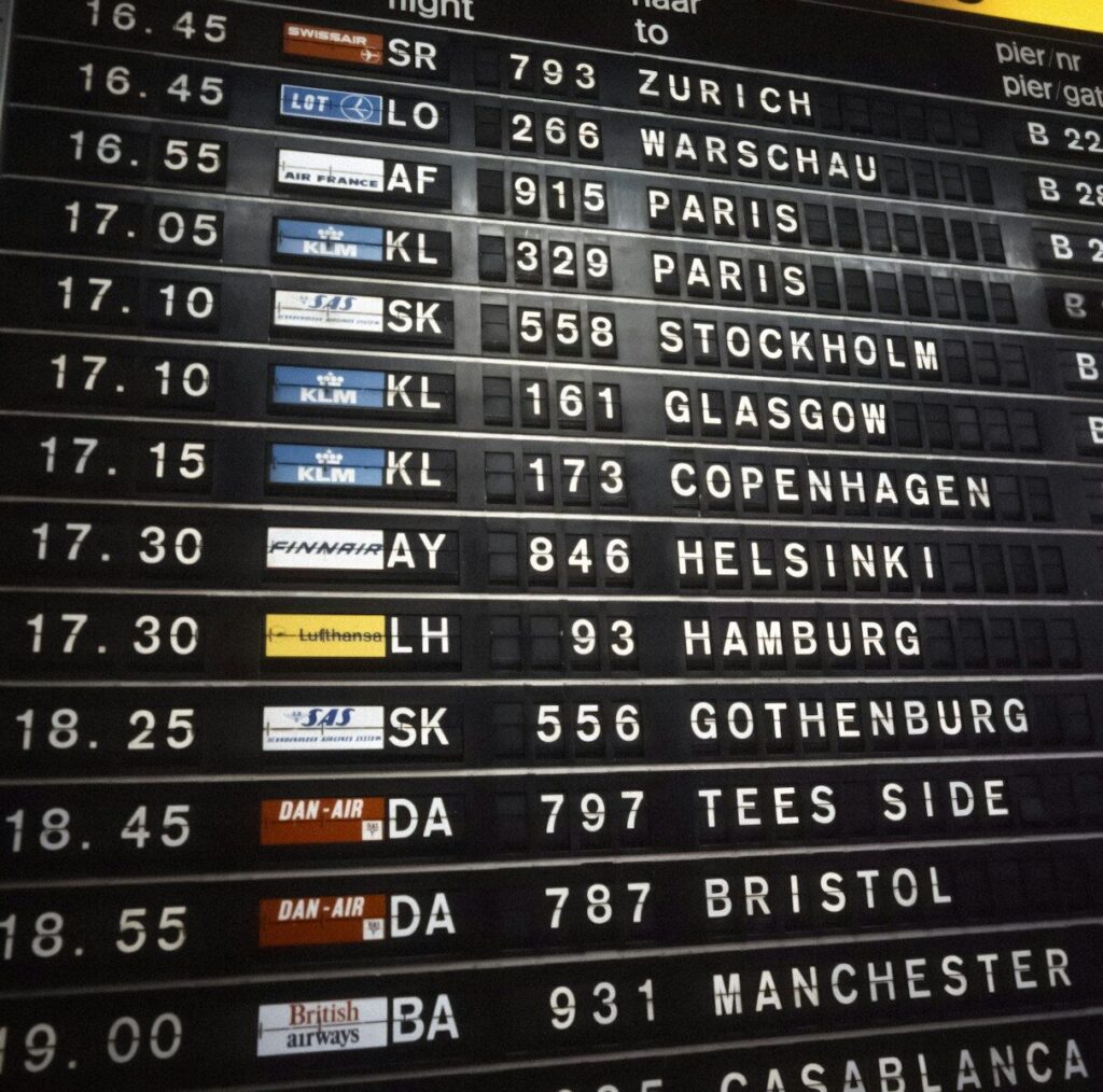 Airport departures board showing flight destinations and times