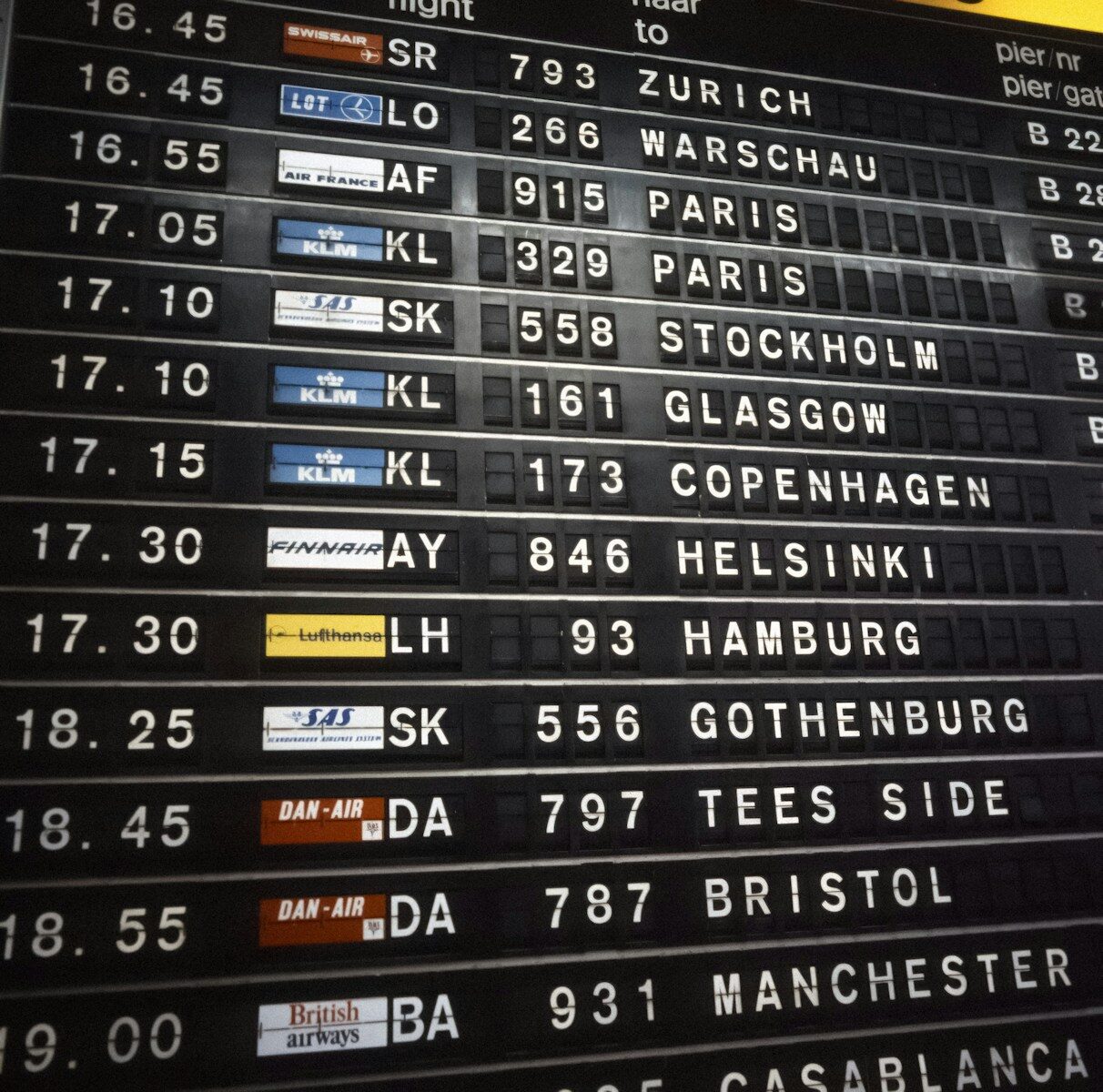 Airport departures board showing flight destinations and times