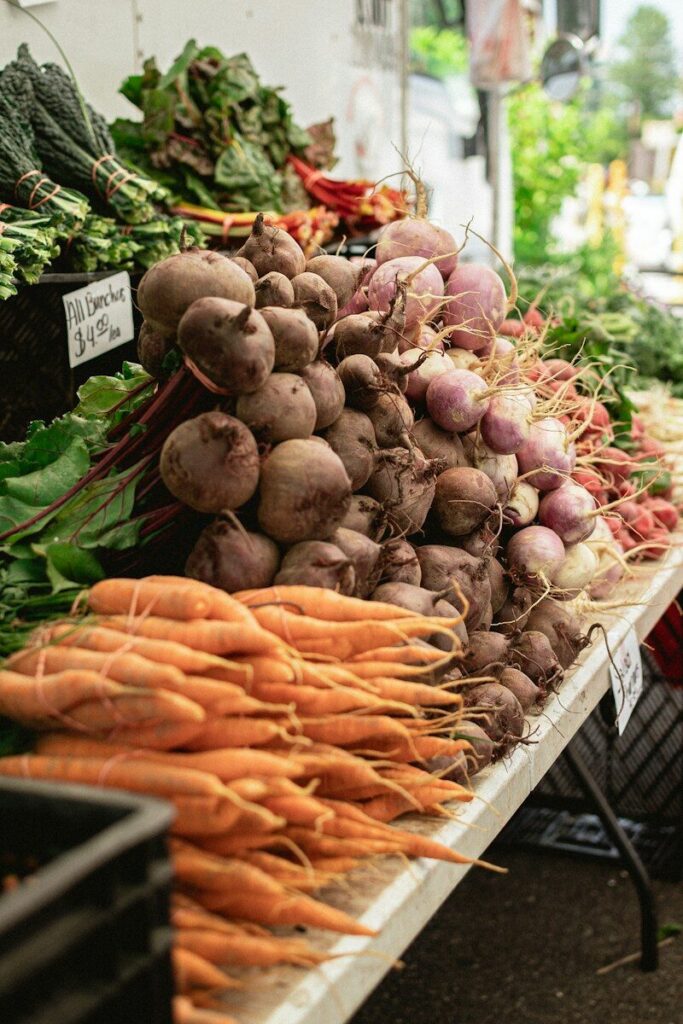 Carrots and vegetables piled on a market stall table