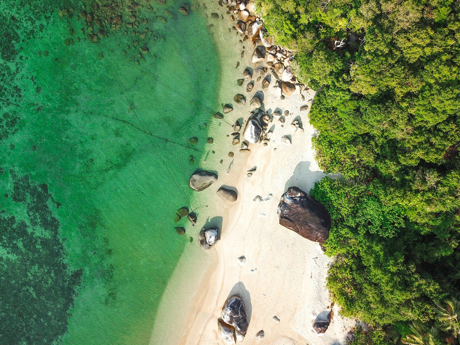 Aerial view of white sand, granite boulders and jungle on the shore of Koh Lipe, Thailand