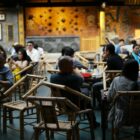 People dining in a dimly lit, ornate restaurant