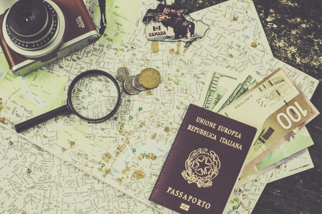 Italian passport and coins on a world map